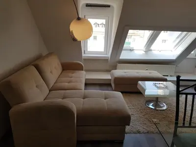 a living room with a couch and a table at Above Ljubljanica River Apartment in Ljubljana