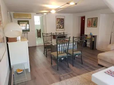 a living room and dining room with a table and chairs at Above Ljubljanica River Apartment in Ljubljana