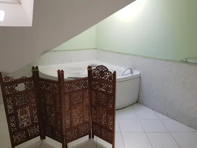 a bathroom with a bath tub in a room at Above Ljubljanica River Apartment in Ljubljana
