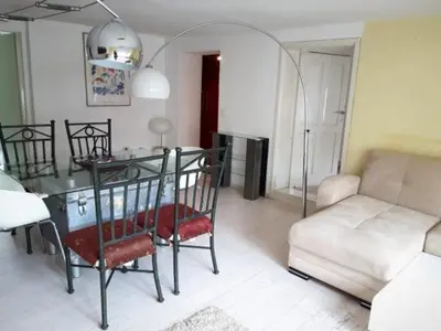 a living room with a table and a couch at Above Ljubljanica River Apartment in Ljubljana
