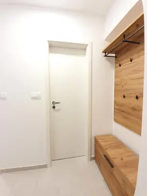 a white door in a room with a wooden wall at Studio Apartment Gea 2 Tour As Ljubljana in Ljubljana