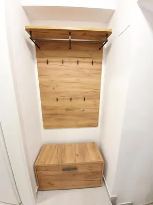 a closet with wooden drawers in a white wall at Studio Apartment Gea 2 Tour As Ljubljana in Ljubljana