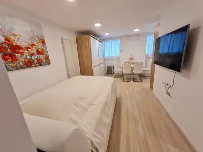 a bedroom with a bed and a flat screen tv at Studio Apartment Gea 2 Tour As Ljubljana in Ljubljana
