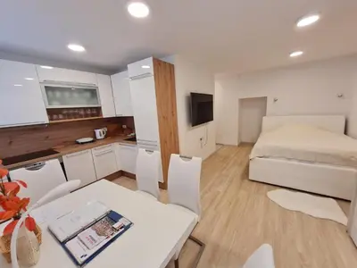 a small room with a bed and a table and chairs at Studio Apartment Gea 2 Tour As Ljubljana in Ljubljana