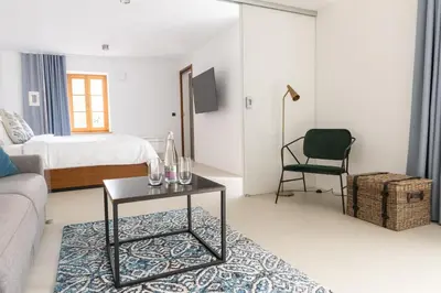 a room with a bed and a table and a chair at Zabjak5 in Ljubljana