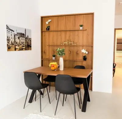 a dining room with a wooden table and chairs at Zabjak5 in Ljubljana