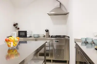 a kitchen with a bowl of fruit on a counter at Zabjak5 in Ljubljana