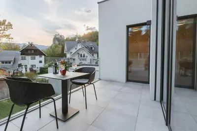 a dining room with a table and chairs on a balcony at Vila Rina in Bled