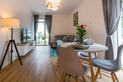 a living room with a white table and chairs at Vila Rina in Bled