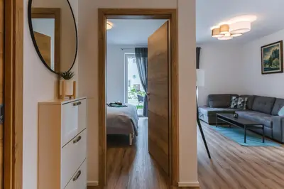 a living room with a mirror and a couch at Vila Rina in Bled