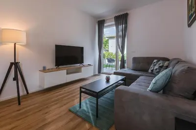 a living room with a couch and a tv at Vila Rina in Bled