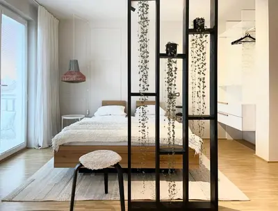 a bedroom with a bed and a chair at Studio XII in Bled