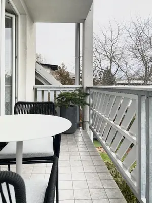 a patio with a table and chairs on a balcony at Studio XII in Bled