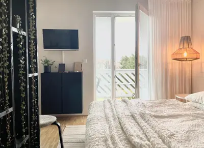 a bedroom with a bed and a large window at Studio XII in Bled