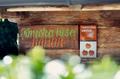 a sign for a barber shop with a sign for a barber at Kmečka hiša Bahor in Črnomelj