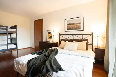 a bedroom with a bed with a blanket on it at Alpine apartments Marcella in Žirovnica