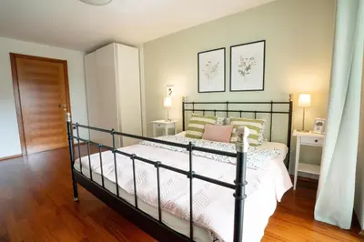 a bedroom with a black bed in a room at Alpine apartments Marcella in Žirovnica