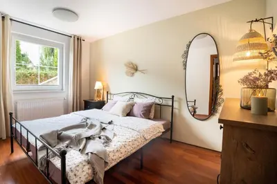 a bedroom with a bed and a mirror at Alpine apartments Marcella in Žirovnica