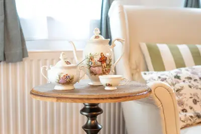 a table with a tea pot and two cups on it at Alpine apartments Marcella in Žirovnica