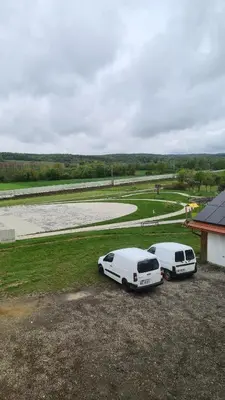 two white cars parked next to a building at Gostišče pri Rudiju in Šalovci