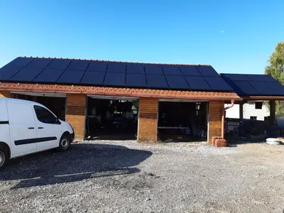a van parked in front of a building with solar panels at Gostišče pri Rudiju in Šalovci