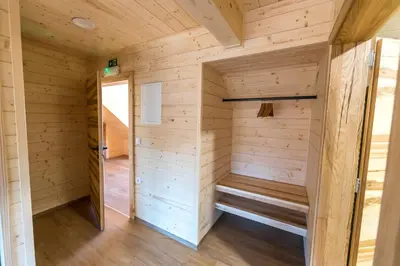 a sauna in a cabin with wooden walls at Apartmaji na kozolcu - Smogavc in Zreče