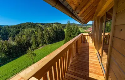 a deck with a view of the mountains at Apartmaji na kozolcu - Smogavc in Zreče