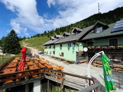 a building with umbrellas in front of it at Pr` Florjan in Cerklje na Gorenjskem