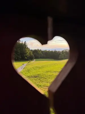 a heart view of a field through a window at Pr` Florjan in Cerklje na Gorenjskem