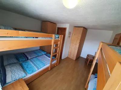 a room with two bunk beds and a table at Pr` Florjan in Cerklje na Gorenjskem