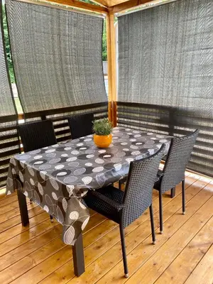 a table with chairs and a table cloth on a porch at Hiša Uran in Kobarid