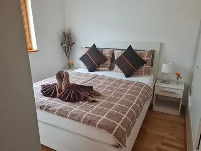 a bedroom with a bed with brown and black pillows at Apartma Svit in Kranjska Gora