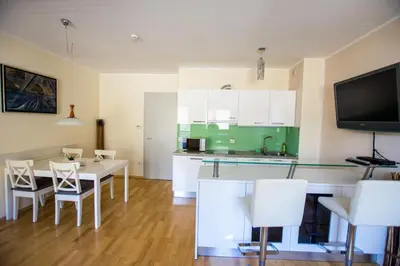 a kitchen and dining room with a table and chairs at Apartma Svit in Kranjska Gora