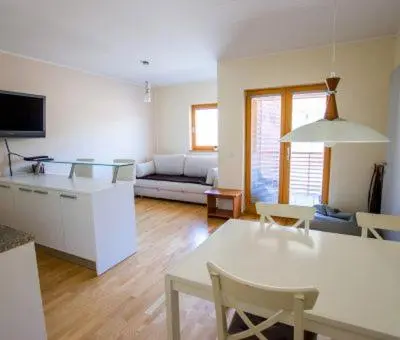a kitchen and living room with a table and chairs at Apartma Svit in Kranjska Gora