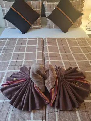 a bed with two towels and pillows on it at Apartma Svit in Kranjska Gora