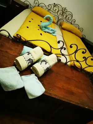a table with three rolled up towels next to a bed at Vila Antik in Ilirska Bistrica