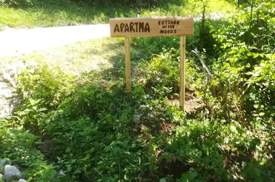 a sign that says antioch garden museum in the grass at Cottage in the woods - Lake Bohinj in Bohinj