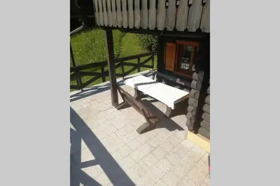 a porch with a bench on a patio at Cottage in the woods - Lake Bohinj in Bohinj