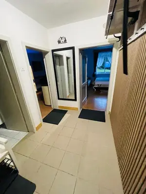 a living room with a tile floor and a hallway at APARTMA ODKLOP Rogla in Lukanja