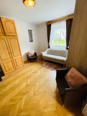 a living room with a couch and a window at APARTMA ODKLOP Rogla in Lukanja