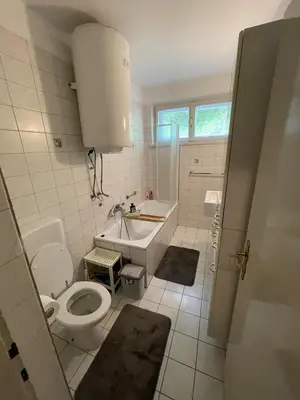 a bathroom with a toilet and a tub and a sink at APARTMA ODKLOP Rogla in Lukanja