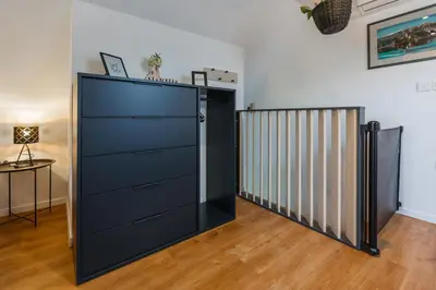 a large black door in a room with a table at Maple & Pine Bled in Bled