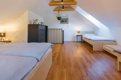 a large room with two beds and a couch at Maple & Pine Bled in Bled