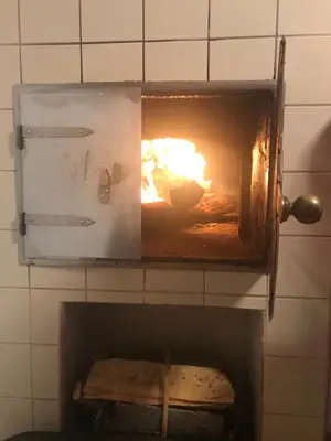 an oven with a fire inside of it at Morning coffee w a view :) in Podčetrtek
