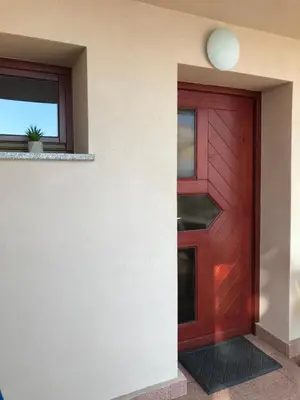 a red door on the side of a building at Morning coffee w a view :) in Podčetrtek