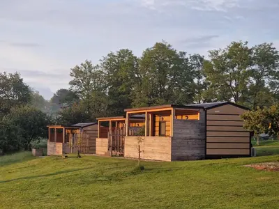 a group of modular homes on a grass field at VINEA PANONIKA wine & mind retreat in Radenci