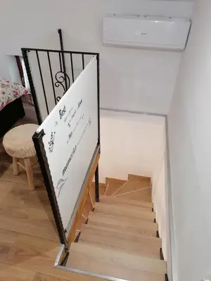 a stairway with a sign with writing on it at Hiša pod Gradičem in Kobarid