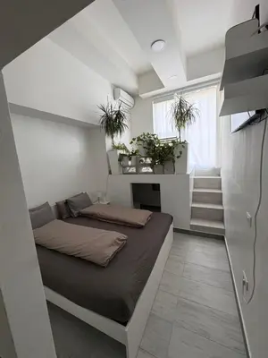 a small bedroom with a bed and a staircase at INDUSTRIAL STUDIO 1 in Ljubljana