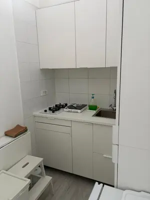 a white kitchen with white cabinets and a sink at INDUSTRIAL STUDIO 1 in Ljubljana