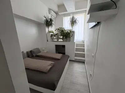 a small room with a bed and a fireplace at INDUSTRIAL STUDIO 1 in Ljubljana